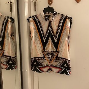 Small geometric pattern orange, black, tan